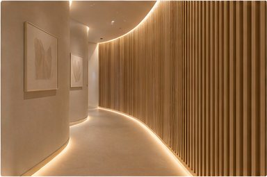 Curved hallway with warm wood paneling at Aurora Luxe Med Spa